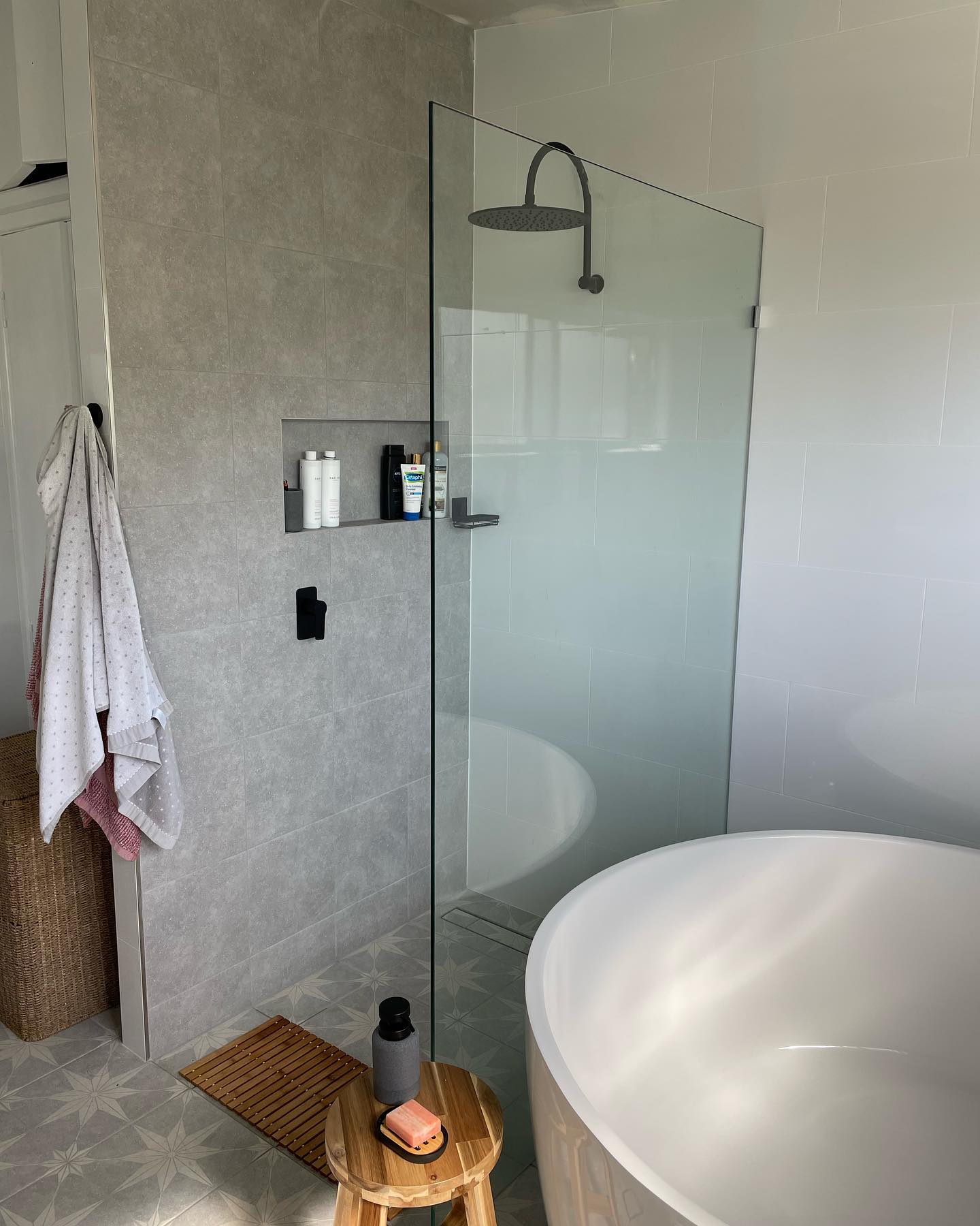 Bathroom Renovation: Frameless walk-in shower and freestanding tub with matte-black tapware.