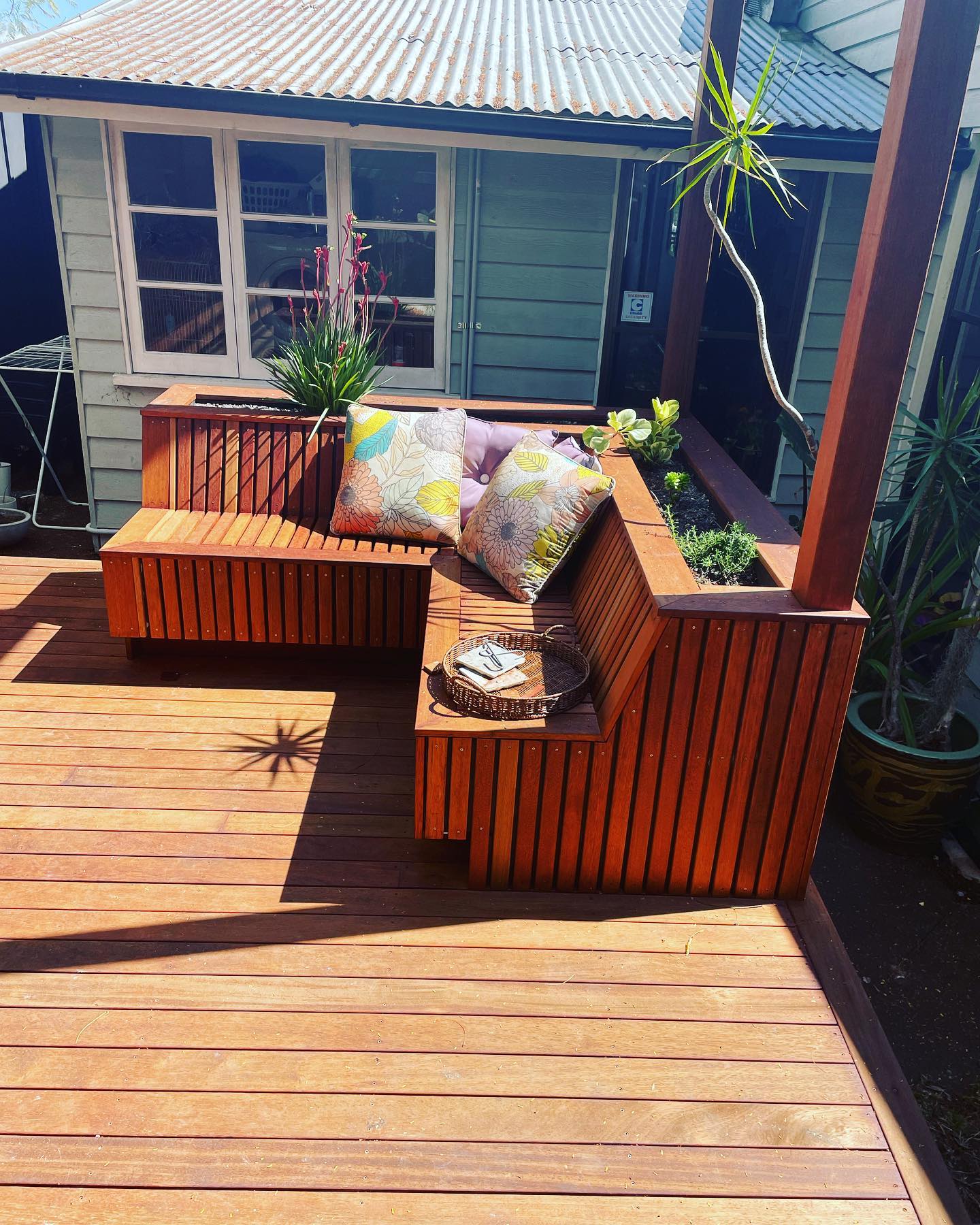 Deck & Bench Seat: Entertaining deck with built-in bench seating and planters.